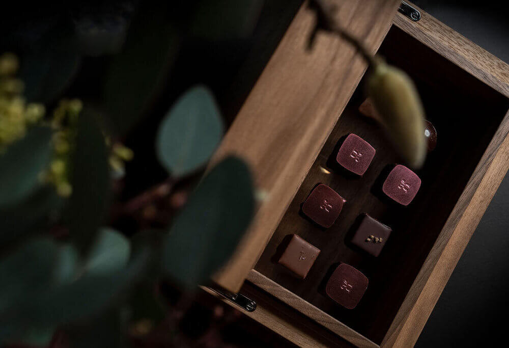 Open box displaying an elegant assortment of handcrafted Swiss chocolates