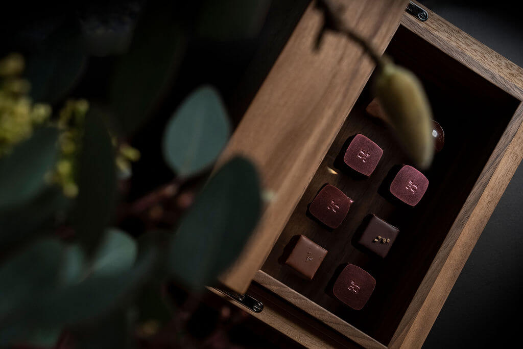 Open box displaying an elegant assortment of handcrafted Swiss chocolates