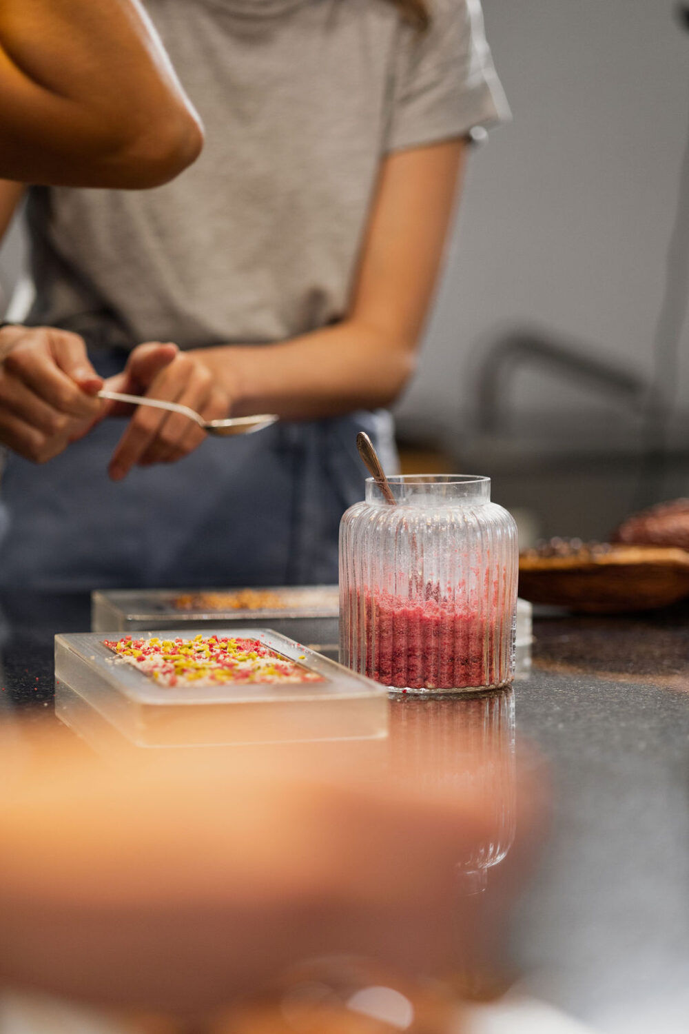 Guest creating a bespoke chocolate bar during a Swiss chocolate workshop