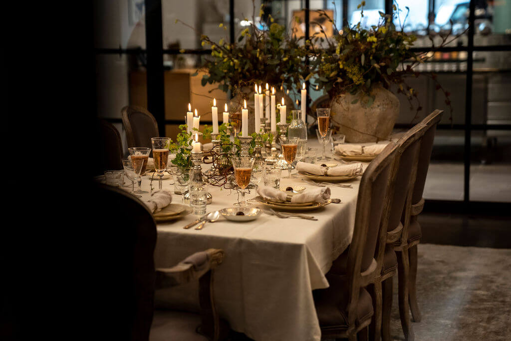 Elegant table setup with candles, tasting dishes, and chocolate plates prepared for a Swiss chocolate tasting experience