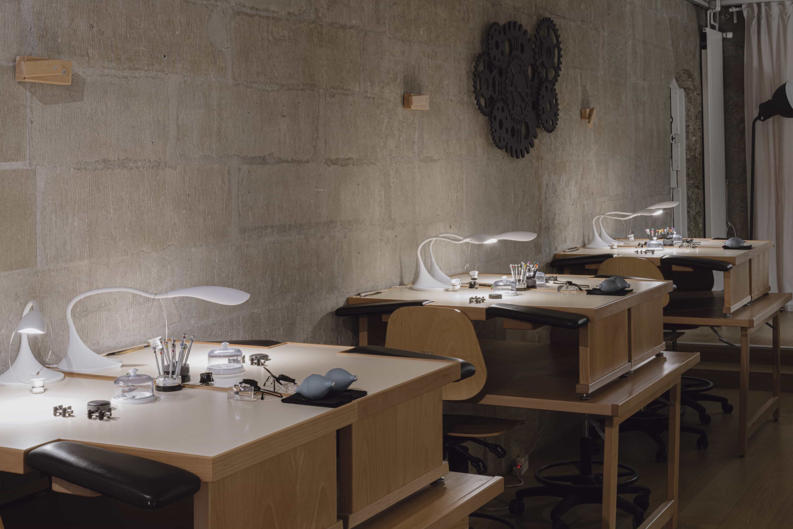 Watchmaking atelier with work tables and precision tools arranged and ready for participants in a Swiss workshop