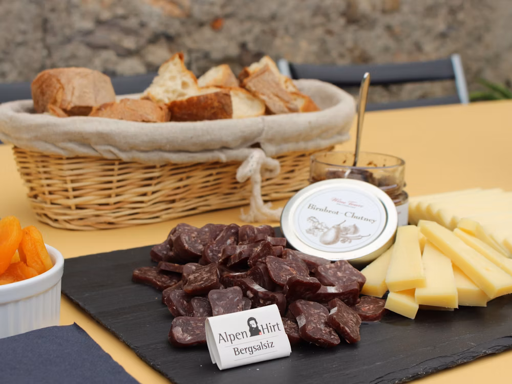Selection of Swiss cheeses and local cured meats served during a wine tasting tour.